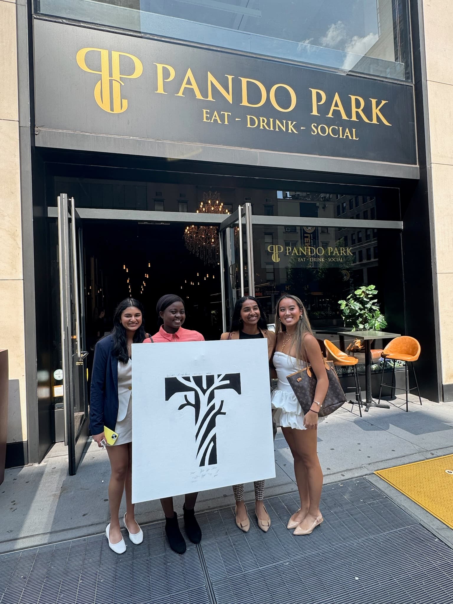 TRIIBE team holding sign